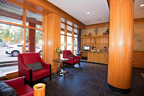 computer in lobby, red leather chairs infront of large windows